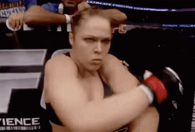 Woman Kneeling In Boxing Ring With Gloves GIF