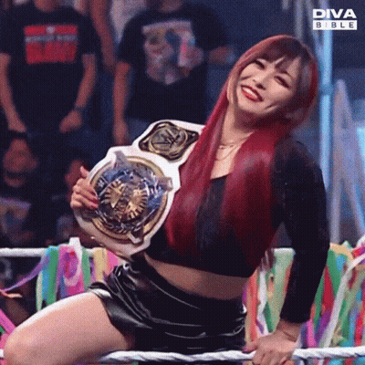 Woman Kneeling In Ring Holding Diva Bible Belt GIF
