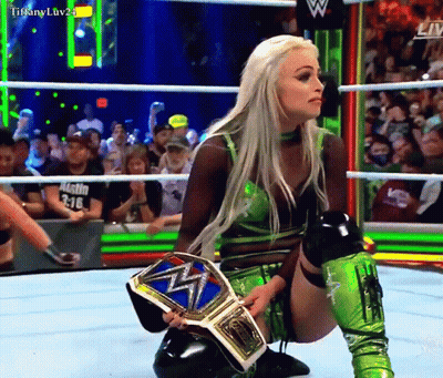 Woman Kneeling In Wrestling Ring Holding Tiffany Luv24 Belt GIF
