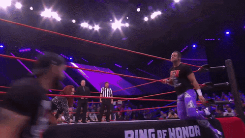Woman Kneeling In Wrestling Ring In Front Of Honor Banner GIF