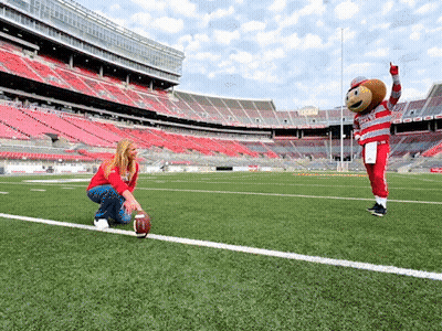 Woman Kneeling Next To Ohio State Football Mascot GIF