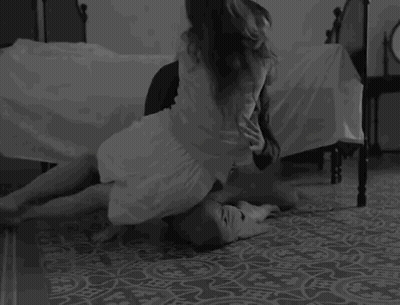Woman Kneeling On Man's Lap In Bedroom GIF