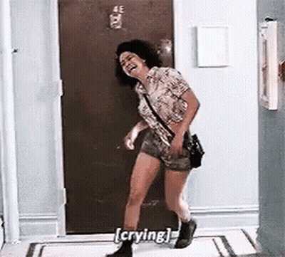 Woman Laughing And Crying In Front Of Door GIF