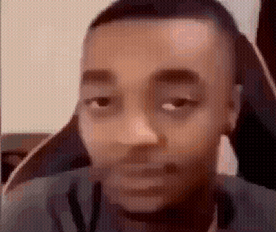 Woman Laughing At Table In Front Of Bookshelf GIF