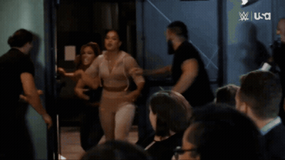 Woman Laughing Before Screen Saying Next Women's North American Championship Ladder Match GIF