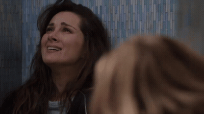 Woman Laughing By Blue Tiled Wall GIF