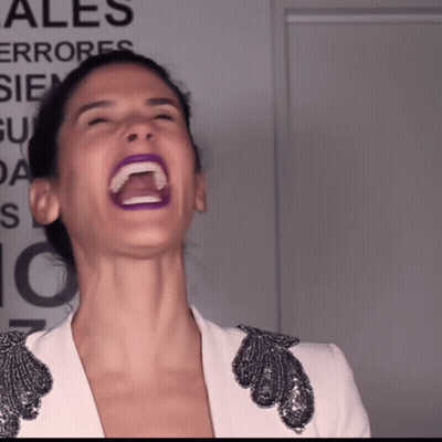 Woman Laughing In Front Of Ales Sign GIF