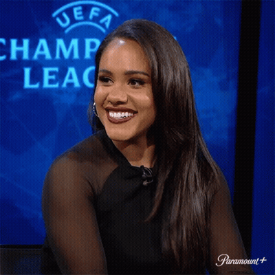 Woman Laughing In Front Of UEFA Champions Logo GIF