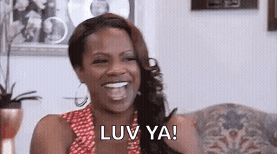 Woman Laughing On Couch GIF
