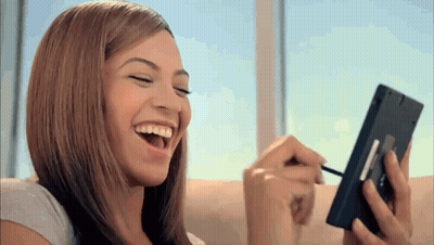 Woman Laughing While Applying Makeup GIF