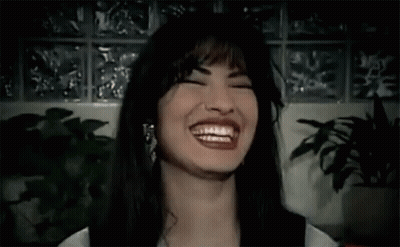 Woman Laughing With Eyes Closed Near Plant GIF
