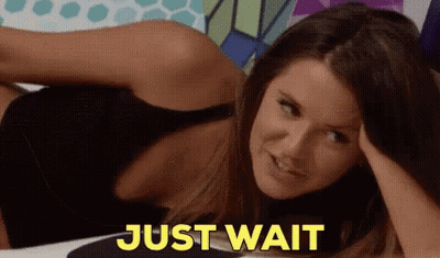 Woman Laying Down Saying Just Wait In Yellow GIF