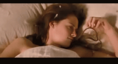 Woman Laying In Bed Eyes Closed Holding Necklace GIF