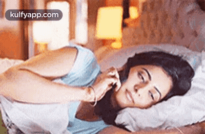 Woman Laying In Bed Eyes Closed Talking On Phone GIF