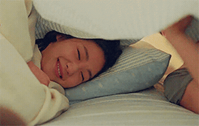 Woman Laying In Bed Smiling Under Blanket GIF