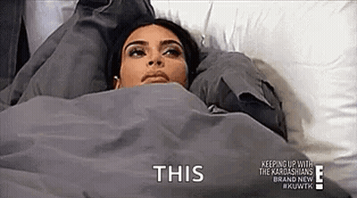 Woman Laying In Bed Under Blanket Saying This GIF