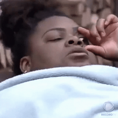 Woman Laying In Bed With Hand On Nose GIF