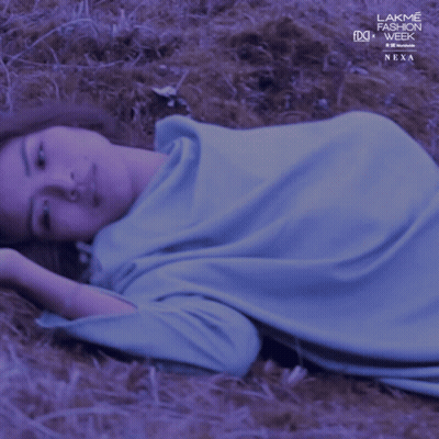 Woman Laying in Grass with Lakme Fashion Week Logo