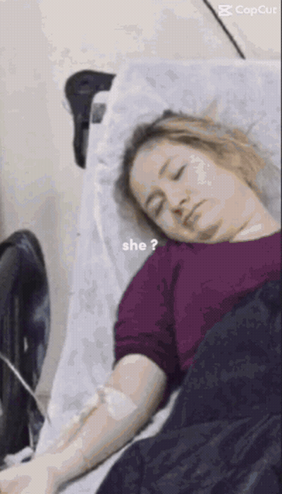 Woman Laying In Hospital Bed With IV And Question Mark GIF