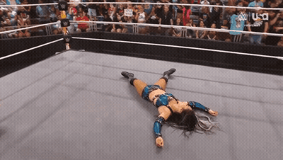 Woman Laying In Wrestling Ring Crowd Watching GIF
