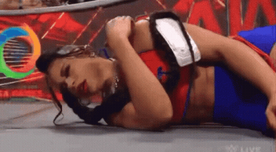 Woman Laying In Wrestling Ring Holding Arm GIF