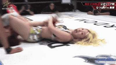 Woman Laying In Wrestling Ring With Stardom Logo GIF