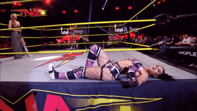 Woman Laying In Wrestling Ring With Word Fatal GIF