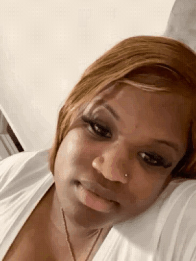 Woman Laying On Bed Head On Pillow Looking At Camera GIF