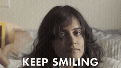 Woman Laying On Bed Keep Smiling On Face GIF