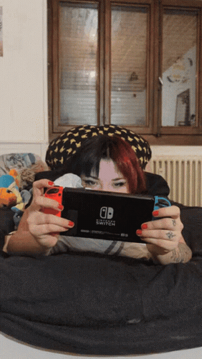 Woman Laying On Bed Playing Nintendo Switch GIF