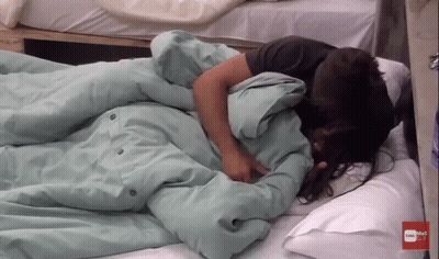 Woman Laying On Bed Saying Subscribe GIF