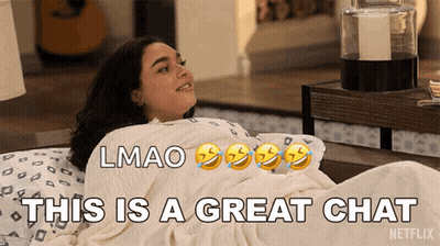Woman Laying On Bed Saying This Is A Great Chat GIF