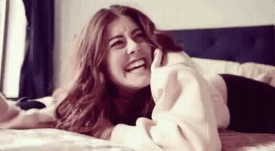 Woman Laying On Bed Smiling GIF