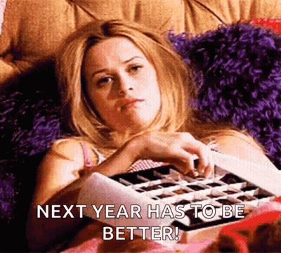Woman Laying On Bed With Chocolates Saying Next Year Has To Be Better GIF