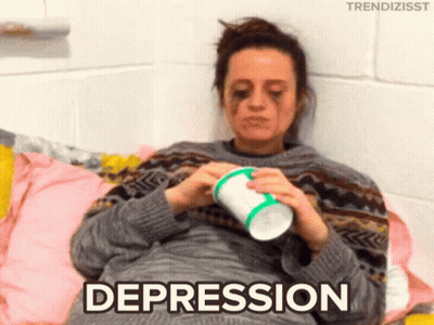 Woman Laying On Bed With Cup Saying Depression GIF