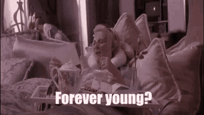 Woman Laying On Bed With Food Tray Forever Young GIF