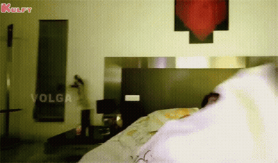 Woman Laying On Bed With Kulfy Sign GIF