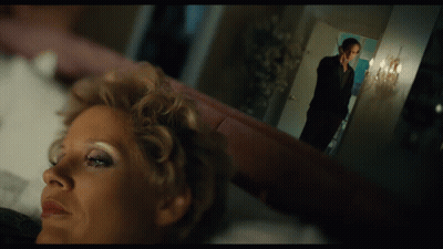 Woman Laying On Bed With Man Standing In Background GIF
