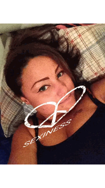 Woman Laying On Bed With Sexiness Sticker