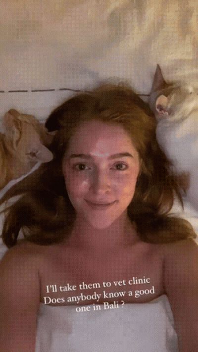 Woman Laying On Bed With Two Cats Saying I'll Take Them To Vet Clinic GIF