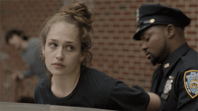 Woman Laying on Car Hood While Police Officer Watches