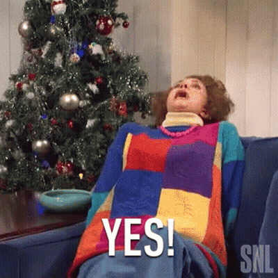 Woman Laying On Couch In Front Of Christmas Tree Saying Yes GIF
