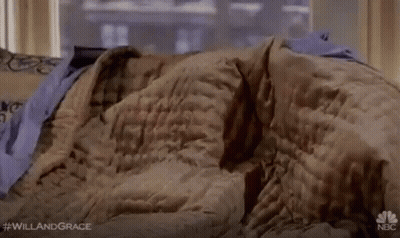 Woman Laying On Couch In Purple Blanket GIF