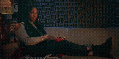 Woman Laying On Couch With Headphones And Phone GIF