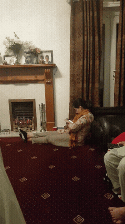 Woman Laying On Floor Looking At Phone GIF