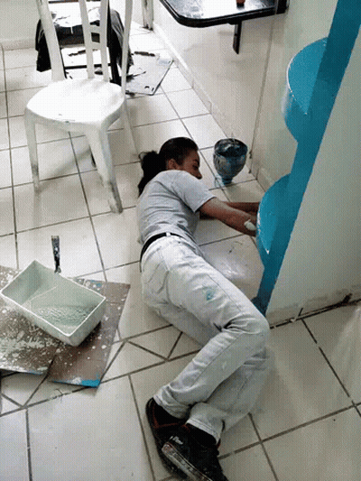 Woman Laying On Floor Painting Wall Blue GIF
