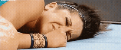 Woman Laying On Ground With Eyes Closed And Hand On Face GIF