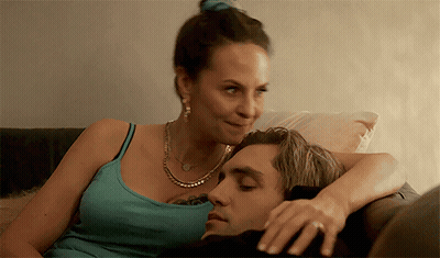 Woman Laying On Man's Lap On Couch GIF