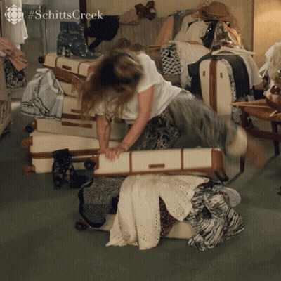 Woman Laying On Stack Of Suitcases Schitts Creek GIF