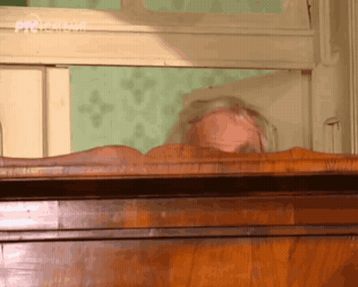 Woman Laying On Wooden Dresser With Prisma GIF